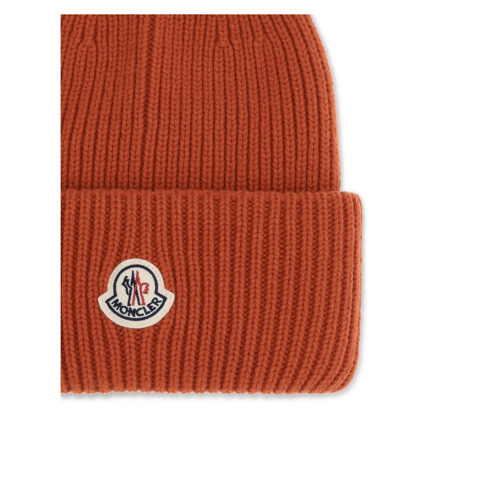 Red Wool BeanieThe beanie Hat by Moncler is crafted from a wool and cashmere blend with a brioche stitch that enhances its softness and style. The heavy knit ensures warmth and comfort, while the iconic felt patch on the front adds a distinctive and recog