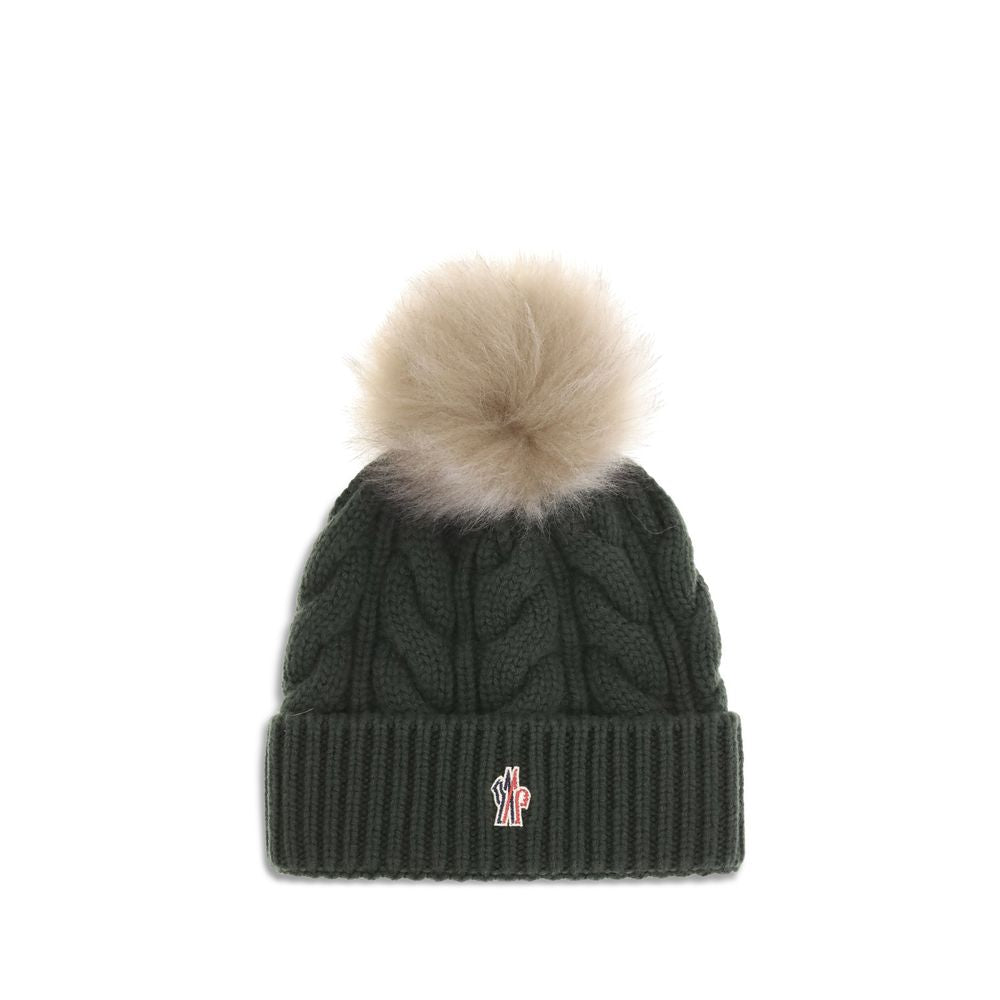 Green Fleece Wool BeanieThe beanie Hat by Moncler Grenoble with pon pon is crafted from a premium wool and cashmere blend for warmth and comfort. It features a long-haired sheepskin pom pom and a 3-gauge Aran cable-knit cuff for a rich, detailed texture.