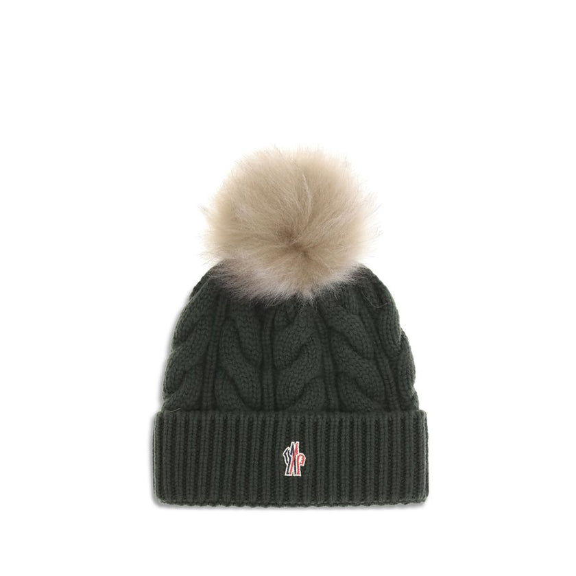 Green Fleece Wool BeanieThe beanie Hat by Moncler Grenoble with pon pon is crafted from a premium wool and cashmere blend for warmth and comfort. It features a long-haired sheepskin pom pom and a 3-gauge Aran cable-knit cuff for a rich, detailed texture.