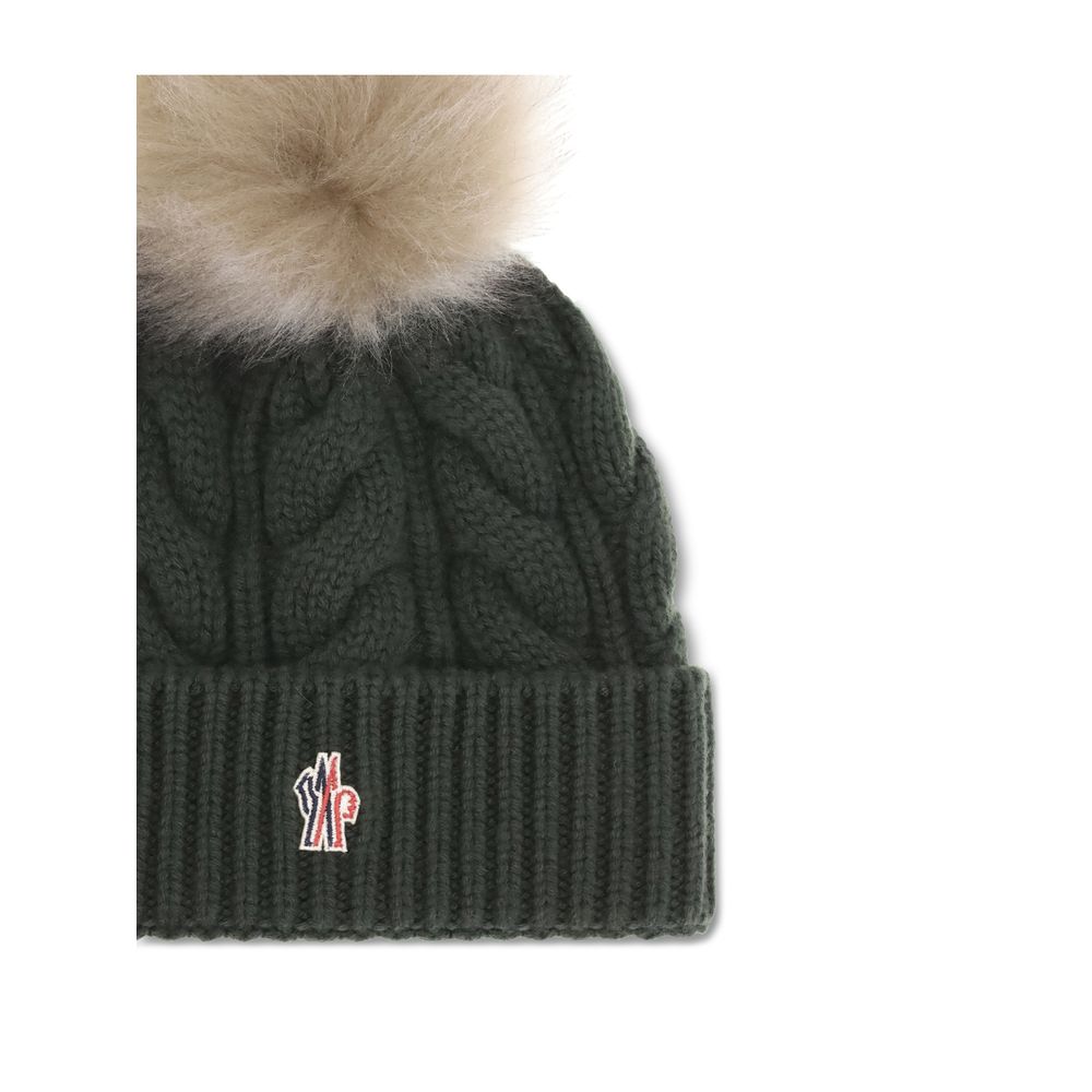 Green Fleece Wool BeanieThe beanie Hat by Moncler Grenoble with pon pon is crafted from a premium wool and cashmere blend for warmth and comfort. It features a long-haired sheepskin pom pom and a 3-gauge Aran cable-knit cuff for a rich, detailed texture.