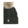 Green Fleece Wool BeanieThe beanie Hat by Moncler Grenoble with pon pon is crafted from a premium wool and cashmere blend for warmth and comfort. It features a long-haired sheepskin pom pom and a 3-gauge Aran cable-knit cuff for a rich, detailed texture.