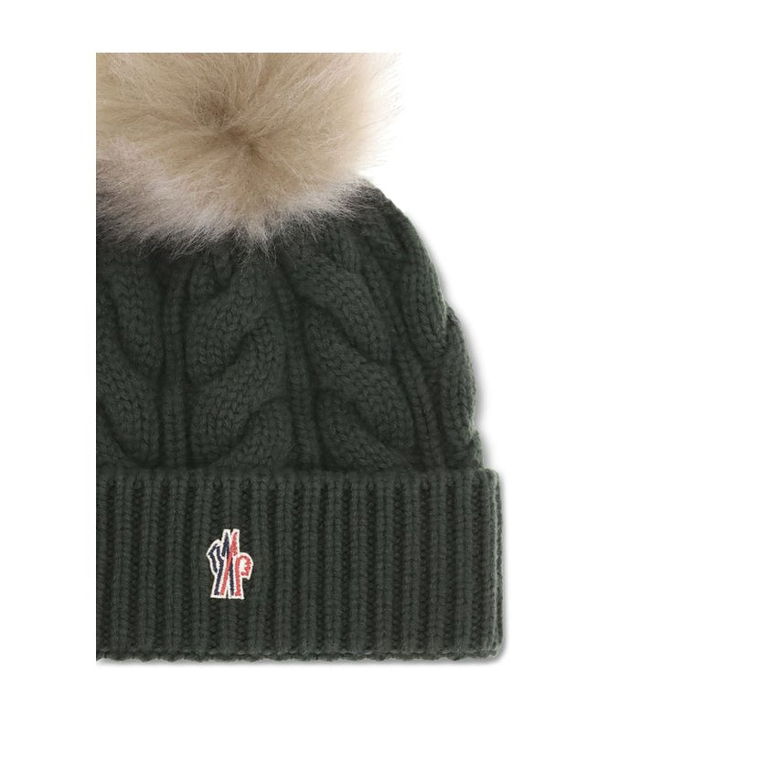Green Fleece Wool BeanieThe beanie Hat by Moncler Grenoble with pon pon is crafted from a premium wool and cashmere blend for warmth and comfort. It features a long-haired sheepskin pom pom and a 3-gauge Aran cable-knit cuff for a rich, detailed texture.