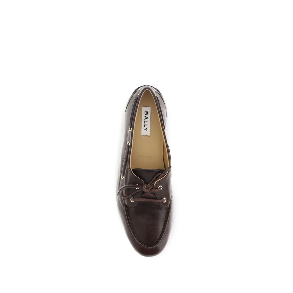 Brown Calf Leather Bos Taurus Slip-On LoafersPathy leather Loafers by Bally feature an almond toe and a boat-inspired design, with a leather ribbon that ties at the front, adding an elegant and refined touch. The leather block heel offers stability and co