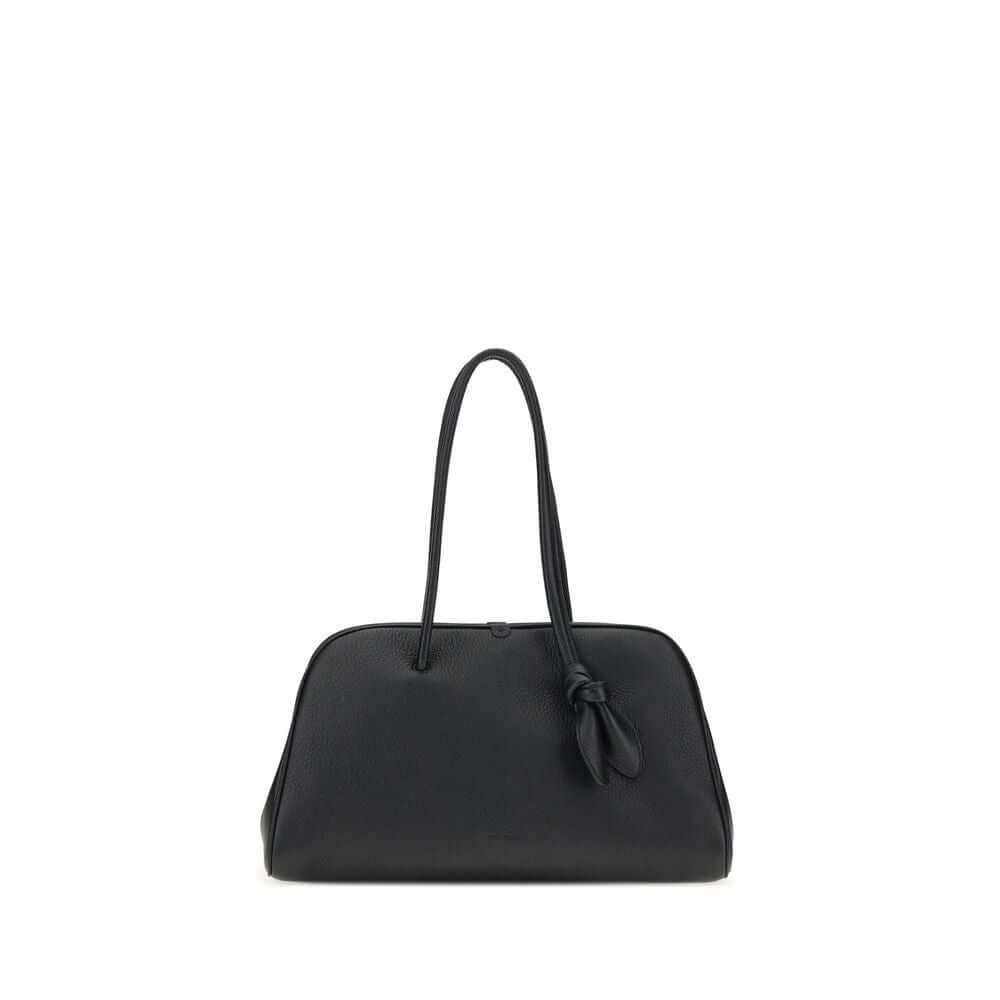 Black Calf Leather Bos Taurus HandbagThe Il Turismo Shoulder Bag by Jacquemus is an elegant reinterpretation of the classic bowling bag, crafted from grainy leather. Featuring a two-way zipper closure, it features a large patch pocket on the front, an int