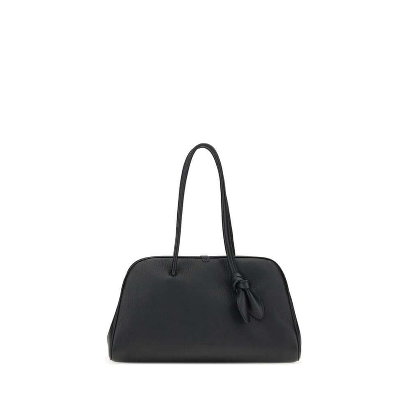Black Calf Leather Bos Taurus HandbagThe Il Turismo Shoulder Bag by Jacquemus is an elegant reinterpretation of the classic bowling bag, crafted from grainy leather. Featuring a two-way zipper closure, it features a large patch pocket on the front, an int