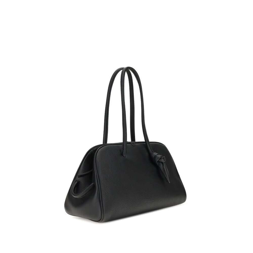 Black Calf Leather Bos Taurus HandbagThe Il Turismo Shoulder Bag by Jacquemus is an elegant reinterpretation of the classic bowling bag, crafted from grainy leather. Featuring a two-way zipper closure, it features a large patch pocket on the front, an int