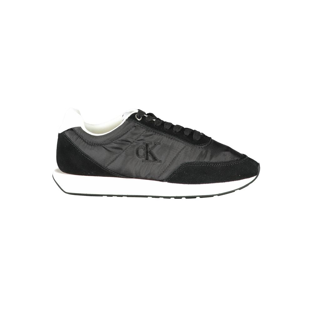 Black Leather Women SneakerStep into the urban jungle with unapologetic style in these Calvin Klein sneakers. Boasting a sleek black aesthetic punctuated by bold contrasting white details, these shoes are a sartorial staple for the fashion-forward. Design