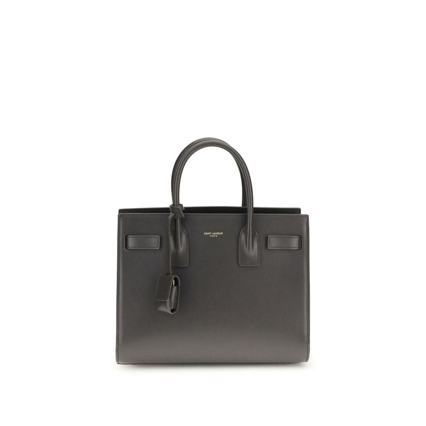 Gray Calf Leather Bos Taurus Shoulder BagThe Sac De Jour Baby leather Handbag by Saint Laurent is an iconic and elegant accessory, crafted from smooth leather and embellished with the brand’s monogram printed on the front. Featuring two round handles, an