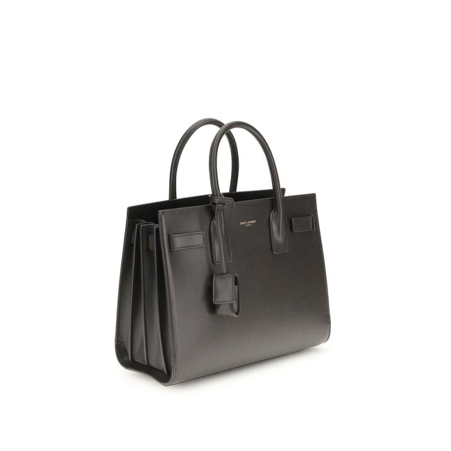 Gray Calf Leather Bos Taurus Shoulder BagThe Sac De Jour Baby leather Handbag by Saint Laurent is an iconic and elegant accessory, crafted from smooth leather and embellished with the brand’s monogram printed on the front. Featuring two round handles, an