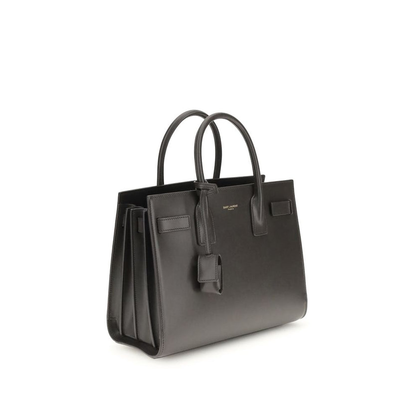 Gray Calf Leather Bos Taurus Shoulder BagThe Sac De Jour Baby leather Handbag by Saint Laurent is an iconic and elegant accessory, crafted from smooth leather and embellished with the brand’s monogram printed on the front. Featuring two round handles, an