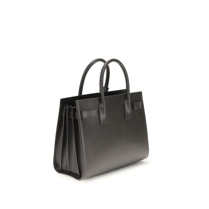 Gray Calf Leather Bos Taurus Shoulder BagThe Sac De Jour Baby leather Handbag by Saint Laurent is an iconic and elegant accessory, crafted from smooth leather and embellished with the brand’s monogram printed on the front. Featuring two round handles, an