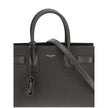 Gray Calf Leather Bos Taurus Shoulder BagThe Sac De Jour Baby leather Handbag by Saint Laurent is an iconic and elegant accessory, crafted from smooth leather and embellished with the brand’s monogram printed on the front. Featuring two round handles, an