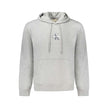 Gray Cotton Mens Hooded SweaterStep into the world of high-end comfort with this Calvin Klein hooded sweatshirt. A statement piece in itself, it features intricate embroidery, showcasing the brand’s iconic logo with a suave touch. Fashioned from a cozy bl
