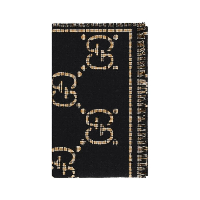 GG ScarfWool Scarf by Gucci features a GG houndstooth jacquard pattern repeated on the front and back, combining the iconic GG monogram with the sophisticated houndstooth motif. Frayed hems add a touch of casual and elegant detail. The scarf measures 47 x