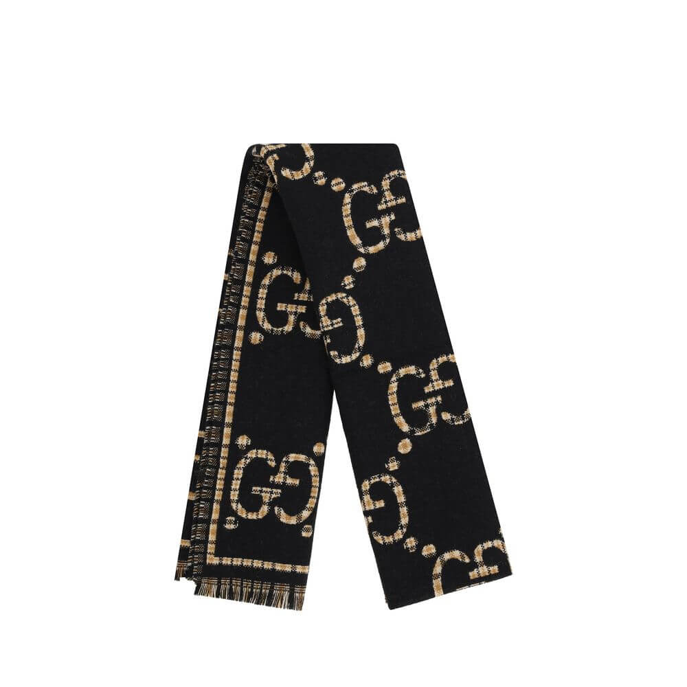 GG ScarfWool Scarf by Gucci features a GG houndstooth jacquard pattern repeated on the front and back, combining the iconic GG monogram with the sophisticated houndstooth motif. Frayed hems add a touch of casual and elegant detail. The scarf measures 47 x