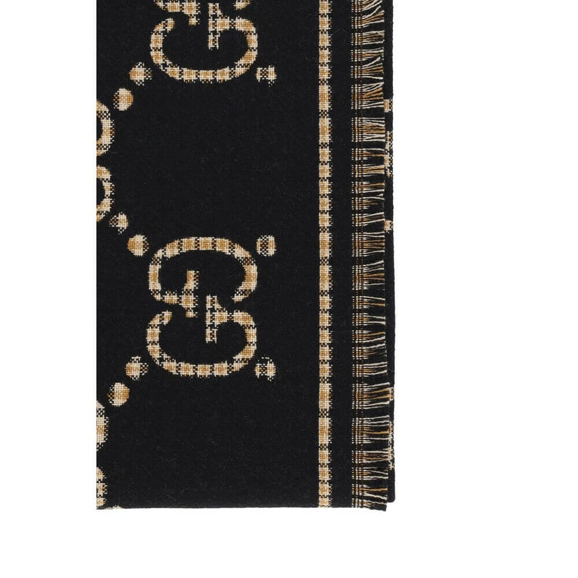 GG ScarfWool Scarf by Gucci features a GG houndstooth jacquard pattern repeated on the front and back, combining the iconic GG monogram with the sophisticated houndstooth motif. Frayed hems add a touch of casual and elegant detail. The scarf measures 47 x