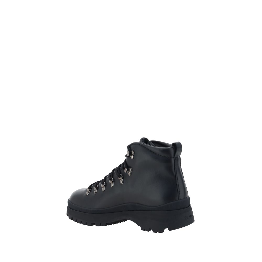 Black Rubber Lace-Up BootsLeather Ankle Boots by Prada reinterpret a wardrobe classic with a bold, contemporary attitude. Featuring a front lace-up closure and a handy pull-on at the back for easy donning, they feature a slip-resistant rubber lug sole tha