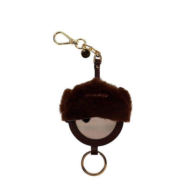Brown Fur KeychainDescription: The product with MPN 5TL205CACAOTABACCO and code F38045 fur in brown is a keychain designed by Miu Miu. It has features like mirror detail, back logo. Additional Info: Materials: Leather Measurements: 7.5×19.5 cm MPN: 5TL205