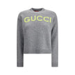 Gray Wool SweatshirtThe Wool Sweater by Gucci embodies the house’s knitwear tradition with a refined, understated design. Ribbed details at the crew neck, cuffs, and hem highlight its classic construction, while the contrasting embroidered monogram at the