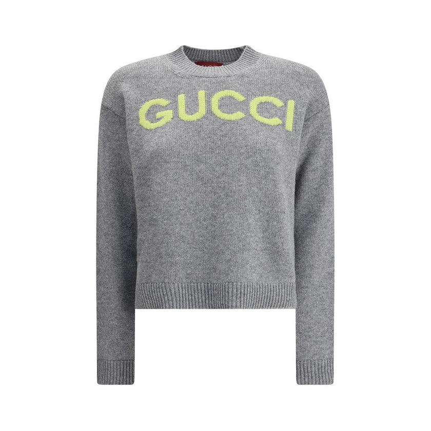 Gray Wool SweatshirtThe Wool Sweater by Gucci embodies the house’s knitwear tradition with a refined, understated design. Ribbed details at the crew neck, cuffs, and hem highlight its classic construction, while the contrasting embroidered monogram at the