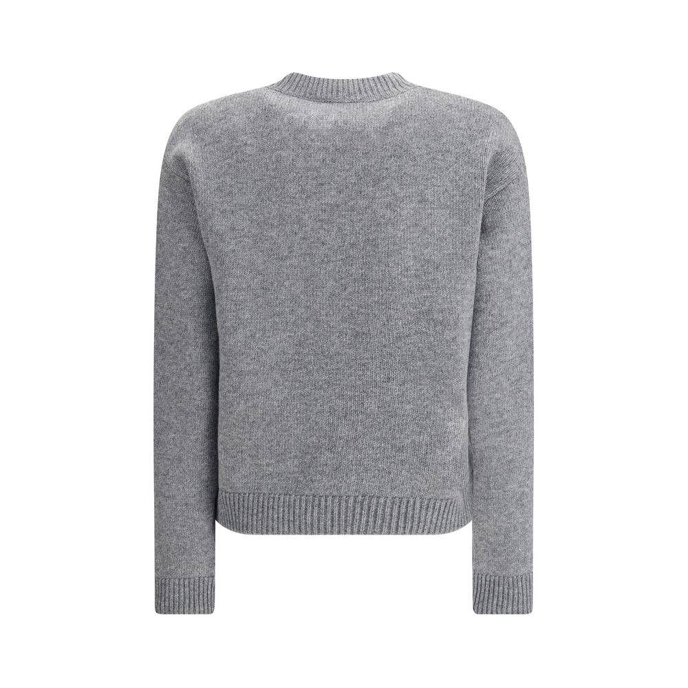 Gray Wool SweatshirtThe Wool Sweater by Gucci embodies the house’s knitwear tradition with a refined, understated design. Ribbed details at the crew neck, cuffs, and hem highlight its classic construction, while the contrasting embroidered monogram at the