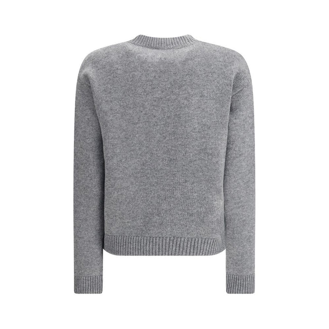 Gray Wool SweatshirtThe Wool Sweater by Gucci embodies the house’s knitwear tradition with a refined, understated design. Ribbed details at the crew neck, cuffs, and hem highlight its classic construction, while the contrasting embroidered monogram at the