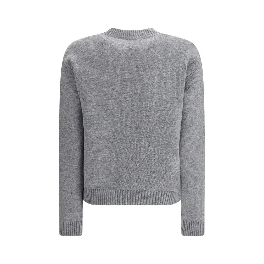 Gray Wool SweatshirtThe Wool Sweater by Gucci embodies the house’s knitwear tradition with a refined, understated design. Ribbed details at the crew neck, cuffs, and hem highlight its classic construction, while the contrasting embroidered monogram at the