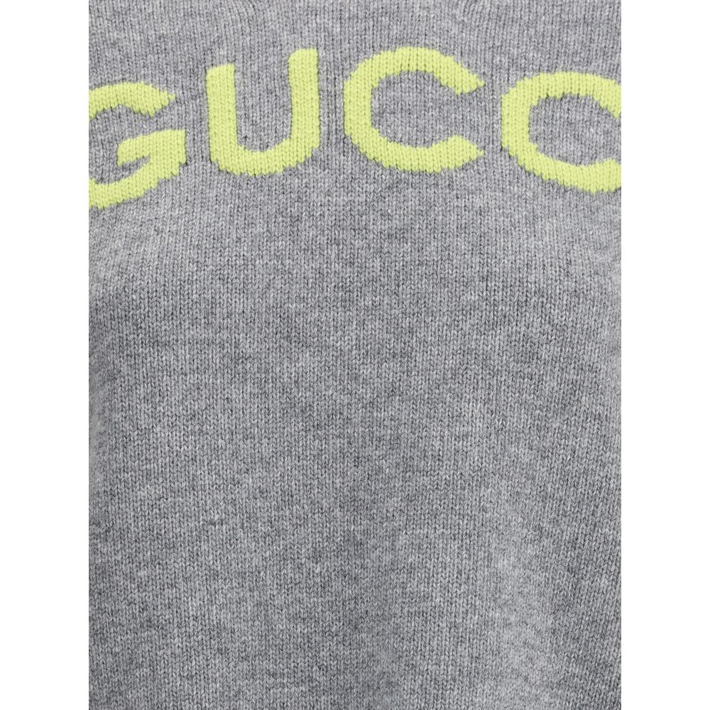 Gray Wool SweatshirtThe Wool Sweater by Gucci embodies the house’s knitwear tradition with a refined, understated design. Ribbed details at the crew neck, cuffs, and hem highlight its classic construction, while the contrasting embroidered monogram at the