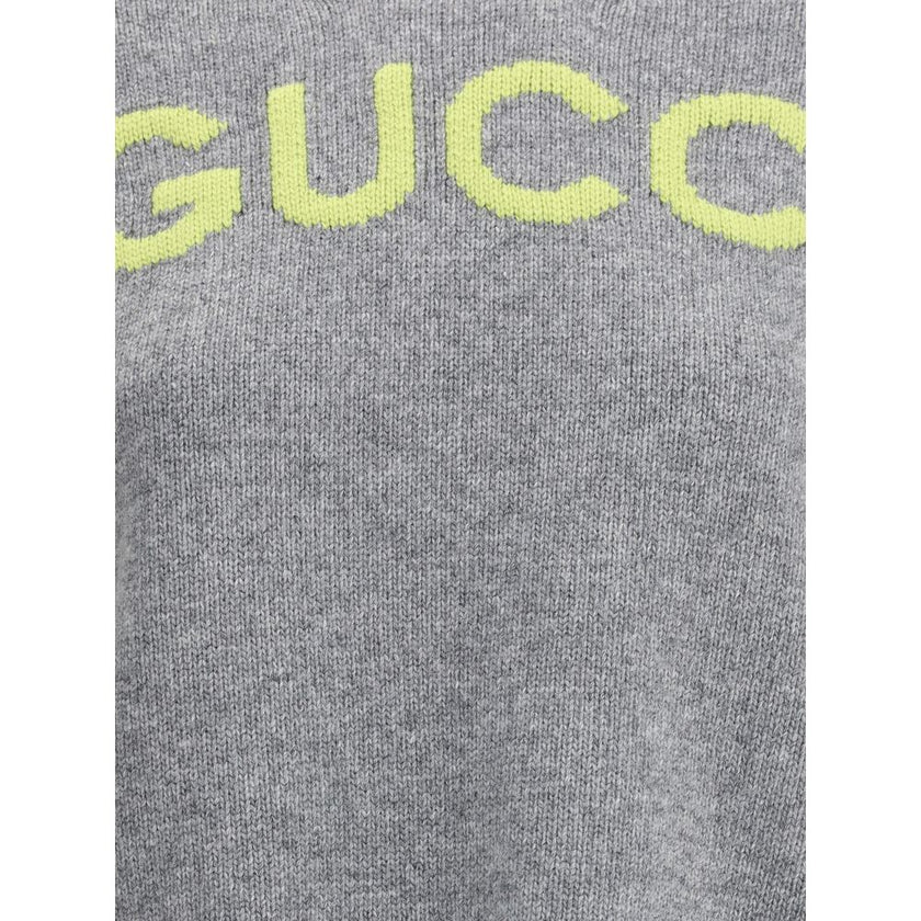 Gray Wool SweatshirtThe Wool Sweater by Gucci embodies the house’s knitwear tradition with a refined, understated design. Ribbed details at the crew neck, cuffs, and hem highlight its classic construction, while the contrasting embroidered monogram at the