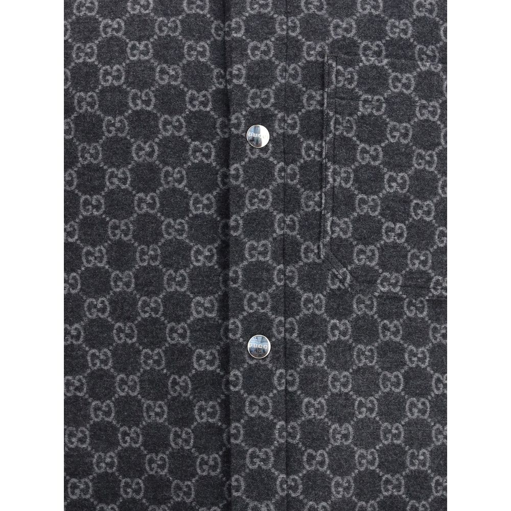 Gray Wool CoatThe Wool Jacket by Gucci embodies refined elegance with unique detailing. An all-over GG monogram defines the surface, while the contrasting classic collar breaks the pattern with sophisticated balance. The front fastening is highlighted by