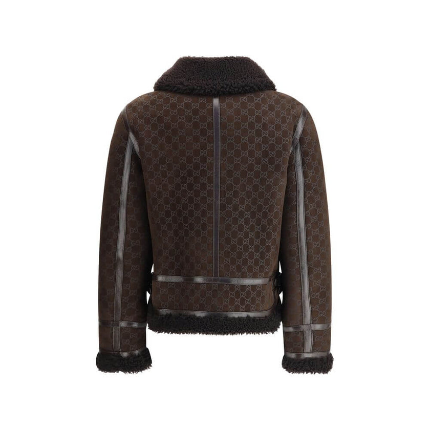 Brown Leather JacketThe Gucci Leather Jacket reimagines women’s outerwear with refined sophistication. Crafted from lambskin embossed with the GG motif, it reflects the maison’s distinctive codes. A shearling collar and lining enhance its warmth and envel