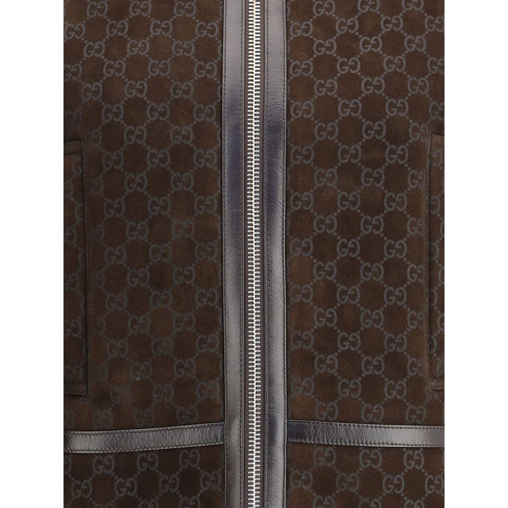 Brown Leather JacketThe Gucci Leather Jacket reimagines women’s outerwear with refined sophistication. Crafted from lambskin embossed with the GG motif, it reflects the maison’s distinctive codes. A shearling collar and lining enhance its warmth and envel