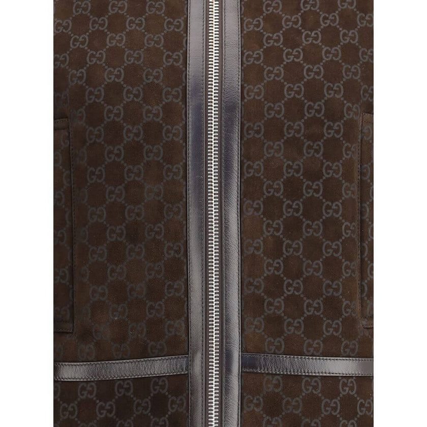 Brown Leather JacketThe Gucci Leather Jacket reimagines women’s outerwear with refined sophistication. Crafted from lambskin embossed with the GG motif, it reflects the maison’s distinctive codes. A shearling collar and lining enhance its warmth and envel