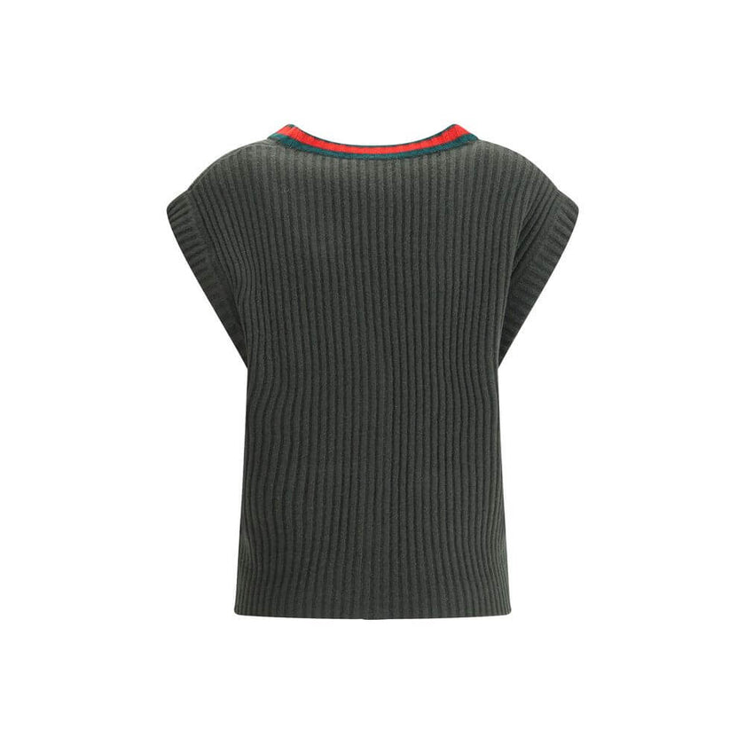 Green Wool Sleeveles SweaterThe Wool Cardigan Vest by Gucci revisits a knitwear essential with refined, contemporary appeal. Its V-neckline and ribbed construction highlight the quality of the yarn, while the contrasting trims add a sharp, graphic accent.