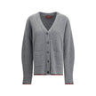 Gray Wool CardiganThe Wool Cardigan by Gucci embodies timeless elegance with its ribbed knit construction and refined V-neckline. Dropped shoulders and long sleeves create a relaxed silhouette, while the maison’s iconic green and red Web trim highlights t