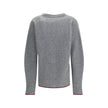 Gray Wool CardiganThe Wool Cardigan by Gucci embodies timeless elegance with its ribbed knit construction and refined V-neckline. Dropped shoulders and long sleeves create a relaxed silhouette, while the maison’s iconic green and red Web trim highlights t