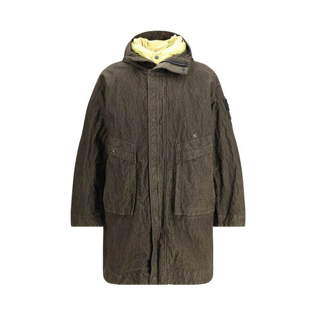 Green Cotton CoatThe wrinkled Corduroy Coat by Stone Island embodies the brand’s commitment to fabric innovation and functional design. Crafted from textured corduroy with a distinctive crinkled effect, it features a dual closure with zip and buttons, two