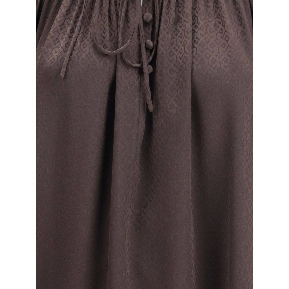 Brown Silk BlouseThe Geometric Silk Blouse by Burberry is crafted in Italy from silk crêpe de chine, jacquard-woven with a geometric pattern inspired by wallpapers found in British stately homes. Designed for a relaxed fit, it features smocking and delica