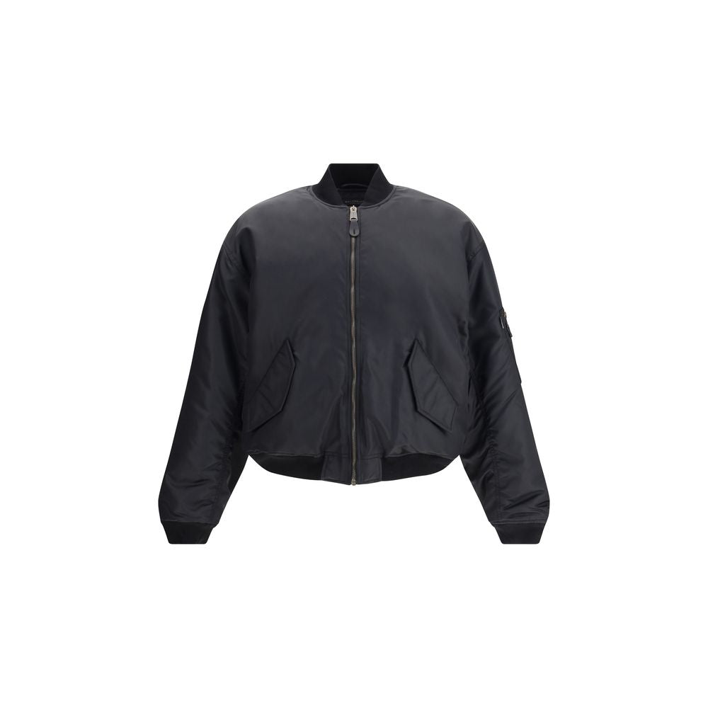 Zipped Standard BomberThe Bomber Standard by Balenciaga reimagines a streetwear classic with the brand’s bold aesthetic. Crafted from recycled satin polyamide, it features a zip closure, two flap pockets with snap buttons at the front, and the iconic zip