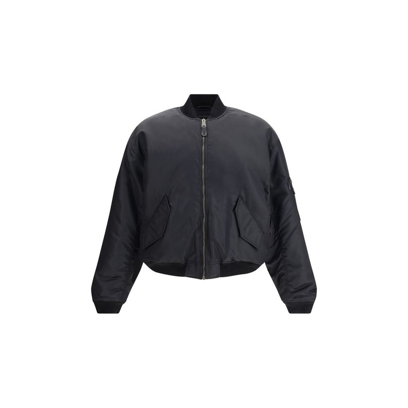 Zipped Standard BomberThe Bomber Standard by Balenciaga reimagines a streetwear classic with the brand’s bold aesthetic. Crafted from recycled satin polyamide, it features a zip closure, two flap pockets with snap buttons at the front, and the iconic zip