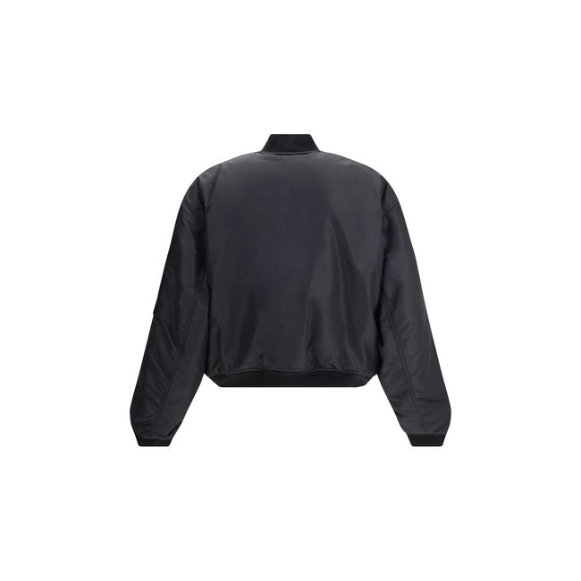 Zipped Standard BomberThe Bomber Standard by Balenciaga reimagines a streetwear classic with the brand’s bold aesthetic. Crafted from recycled satin polyamide, it features a zip closure, two flap pockets with snap buttons at the front, and the iconic zip
