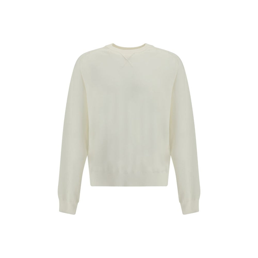 Crew-neck Sweater in merino woolThe crew-neck Sweater by Jacquemus, crafted from off-white merino wool, reflects effortless elegance. Overlock stitching beneath the neckline introduces a contemporary touch, while ribbed edges subtly define the relaxed sil