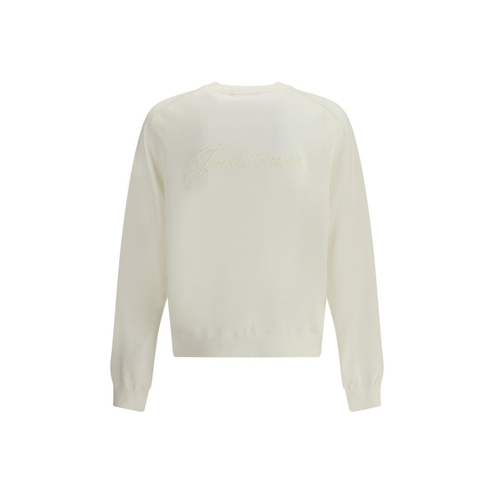 Crew-neck Sweater in merino woolThe crew-neck Sweater by Jacquemus, crafted from off-white merino wool, reflects effortless elegance. Overlock stitching beneath the neckline introduces a contemporary touch, while ribbed edges subtly define the relaxed sil