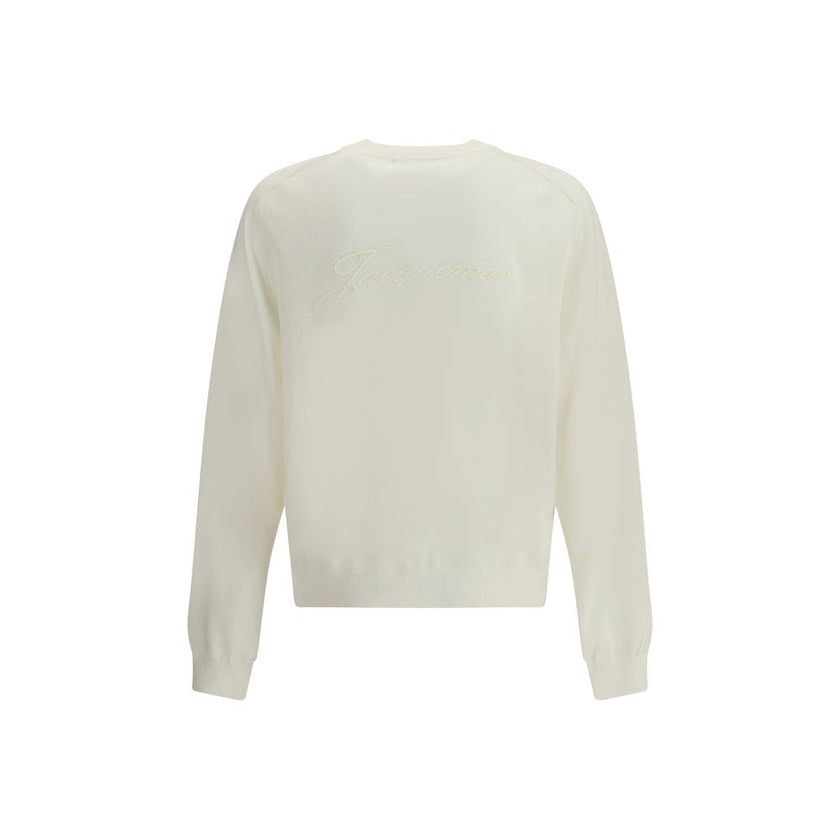 Crew-neck Sweater in merino woolThe crew-neck Sweater by Jacquemus, crafted from off-white merino wool, reflects effortless elegance. Overlock stitching beneath the neckline introduces a contemporary touch, while ribbed edges subtly define the relaxed sil