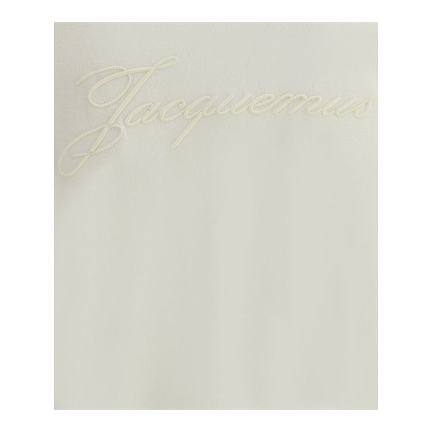 Crew-neck Sweater in merino woolThe crew-neck Sweater by Jacquemus, crafted from off-white merino wool, reflects effortless elegance. Overlock stitching beneath the neckline introduces a contemporary touch, while ribbed edges subtly define the relaxed sil