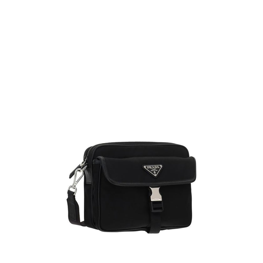 Black Polyamide Shoulder BagNylon Shoulder Bag by Prada, adjustable and removable shoulder strap with embroidered brand signature, removable mini pouch with zipper, triangular brand monogram plaque applied embossed on pouch, front push lock closure, iconi