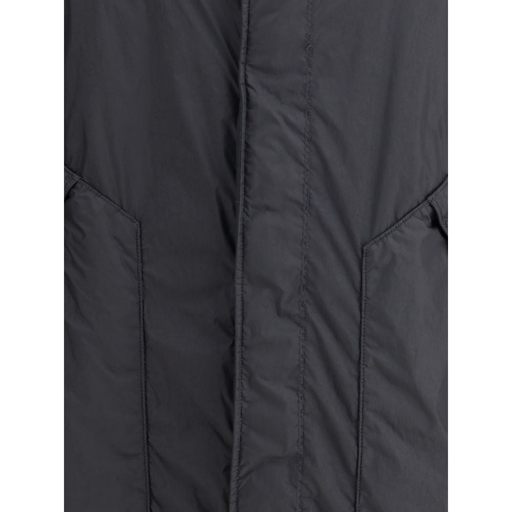 Long Down JacketStone Island’s long Down Jacket combines protection and style in a functional design. Featuring an adjustable drawstring hood and front zipper and snap-button closure, it has two maxi patch pockets on the front and an adjustable hem for a