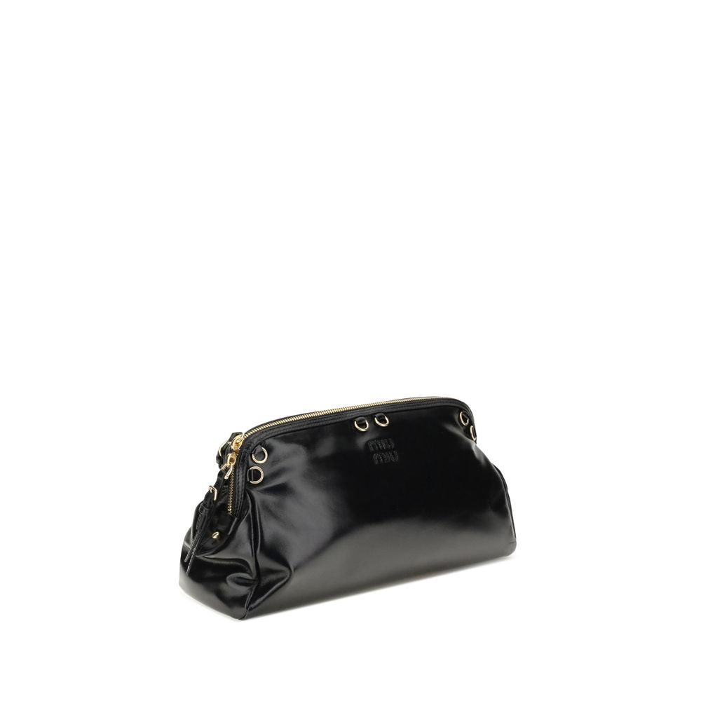 Black Calf Leather Bos Taurus Shoulder BagThe Softy Shoulder Bag by Miu Miu combines functionality and contemporary style. Featuring a double zip closure on the top, it has two adjustable and removable handles for versatile carrying. Decorative eyelets ad