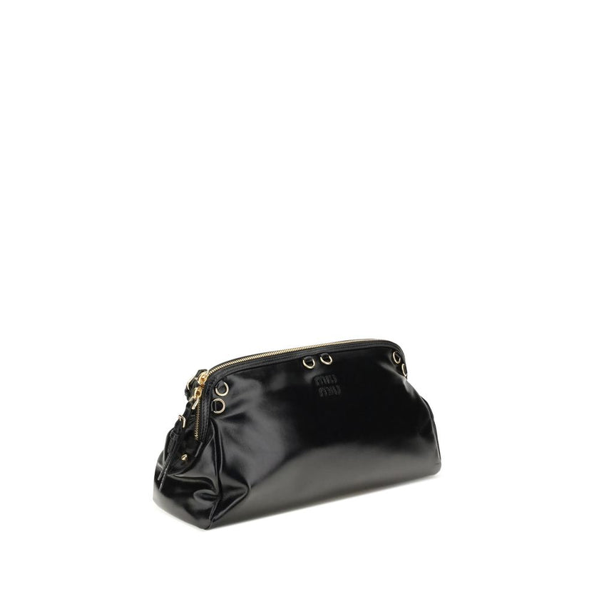 Black Calf Leather Bos Taurus Shoulder BagThe Softy Shoulder Bag by Miu Miu combines functionality and contemporary style. Featuring a double zip closure on the top, it has two adjustable and removable handles for versatile carrying. Decorative eyelets ad