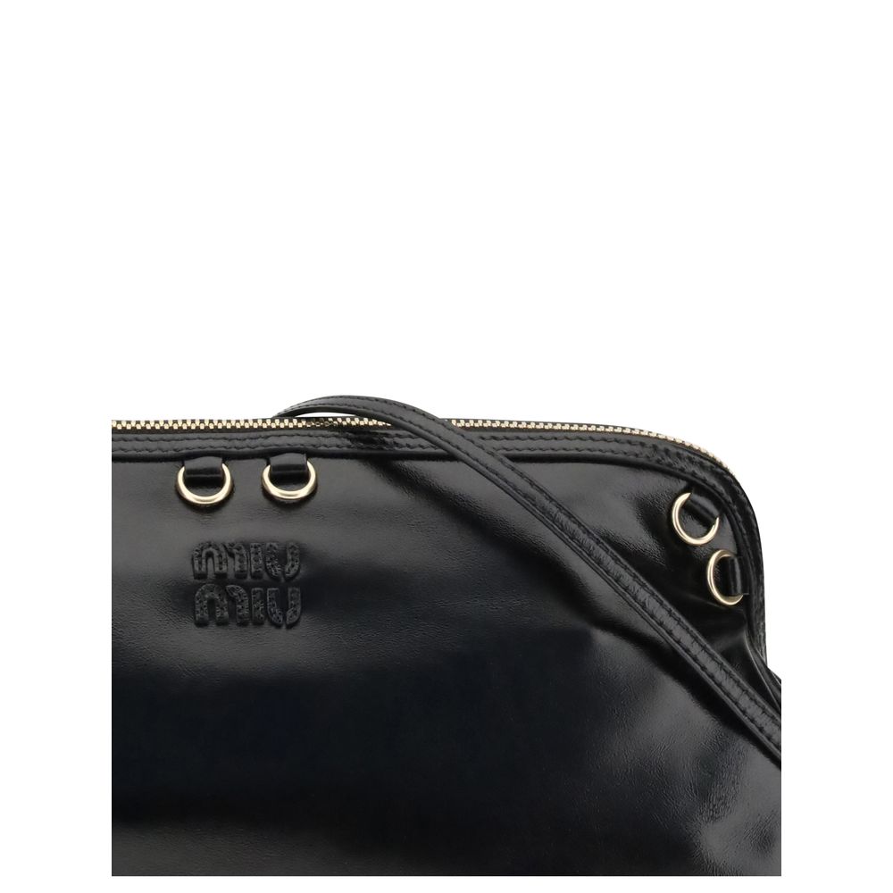 Black Calf Leather Bos Taurus Shoulder BagThe Softy Shoulder Bag by Miu Miu combines functionality and contemporary style. Featuring a double zip closure on the top, it has two adjustable and removable handles for versatile carrying. Decorative eyelets ad